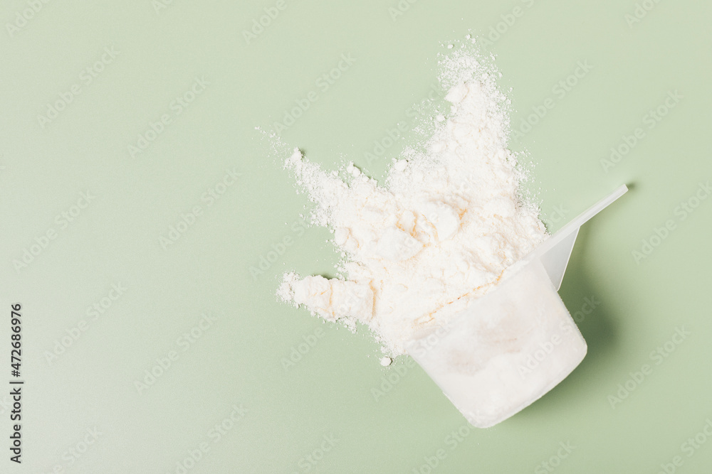 Whey protein powder sports nutrition scattered from measuring Whey protein powder sports nutrition scattered from measuring