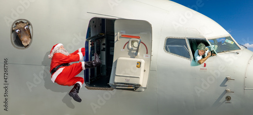 Santa Claus is trying to board a flying plane
