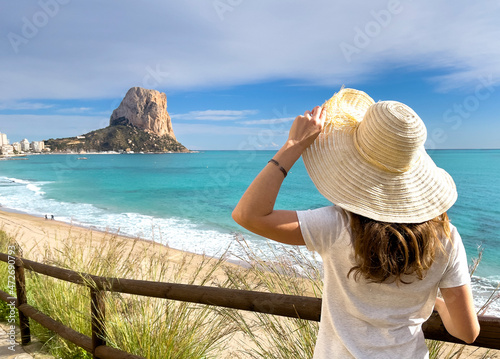 traveler woman arms raised and beautiful view of mediterranean sea- Calp, costa blanca in Spain photo