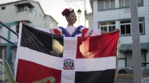 dominican girl holding a dominican flag