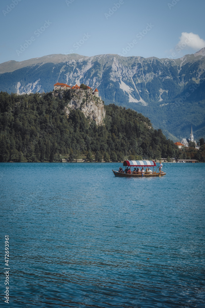 landscape on a lake surrounded by mountains and with a boat landscape on a lake surrounded by mountains and with a boat