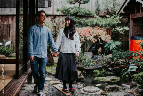 Canvas Print Young japanese couple spending time in their house