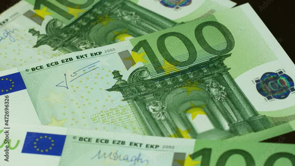 Close up of 100 euro banknotes rotating. European currency cash money. Stock market and currency exchange. Growth of quotations of European money. Selective focus, shallow depth of field Close up of 100 euro banknotes rotating. European currency cash money. Stock market and currency exchange. Growth of quotations of European money. Selective focus, shallow depth of field