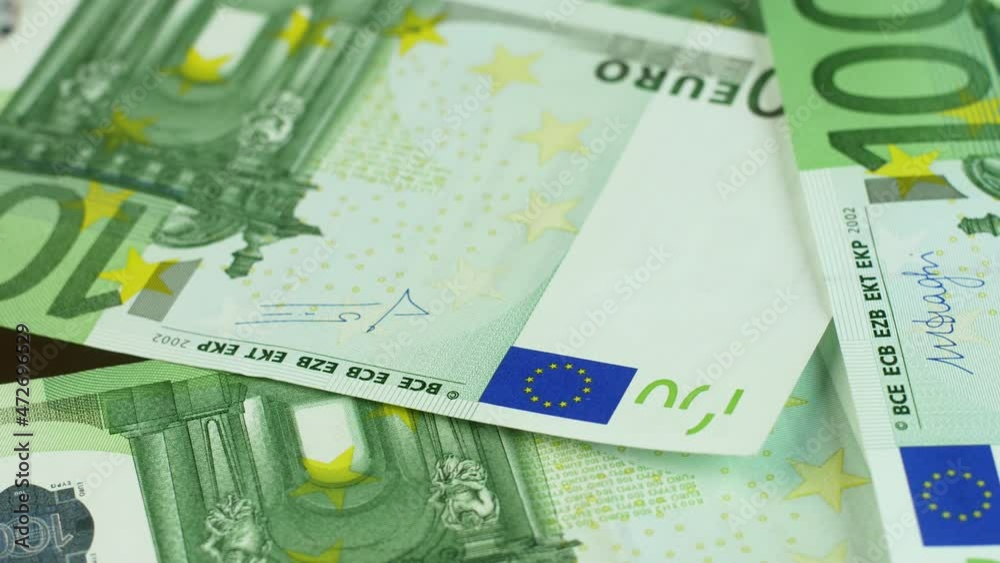 Close-up of 100 euro banknotes rotate. Fall in European markets. Growth in the price of the European currency. Selective focus. Economy and monetary circulation of the EU countries Close-up of 100 euro banknotes rotate. Fall in European markets. Growth in the price of the European currency. Selective focus. Economy and monetary circulation of the EU countries
