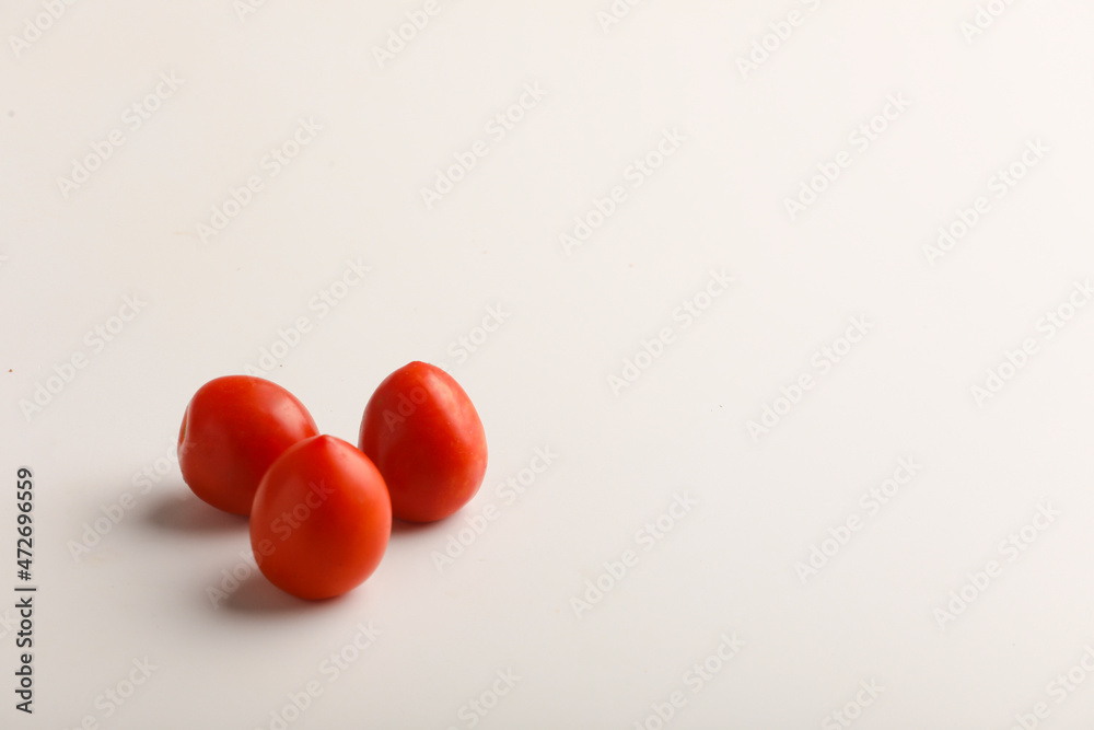 Fresh red tomato on white background.