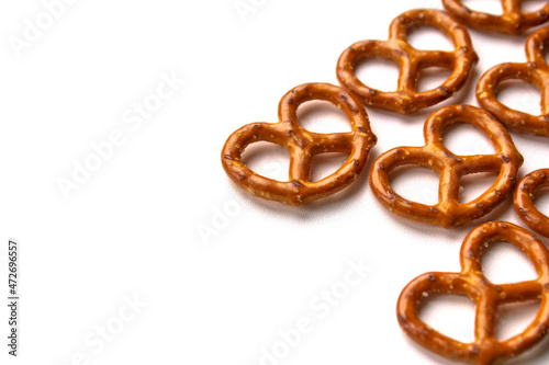 Crispy salty pretzels are laid out on a white background. Top view. Concept: quick snack, food photography, holidays and vacations, cafes and bistros, Christmas food.