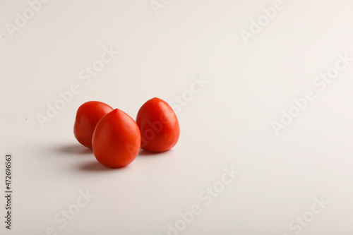Fresh red tomato on white background. © Bilal