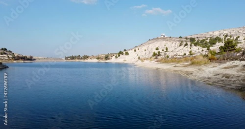 Wallpaper Mural Aerial shot over a water reservoir dam surrounded by small hills and mountains over a blue sky day Torontodigital.ca