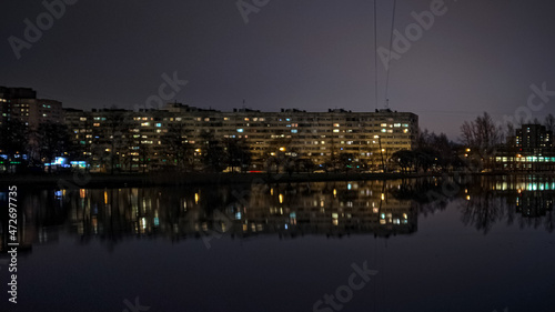 building and reflection in the pond at night