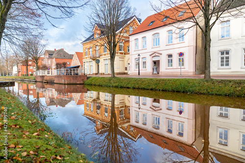 View of pastel colored houses along the canal in Papenburg, Germany