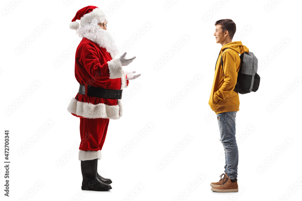 Santa Claus standing and talking to a male teenage student