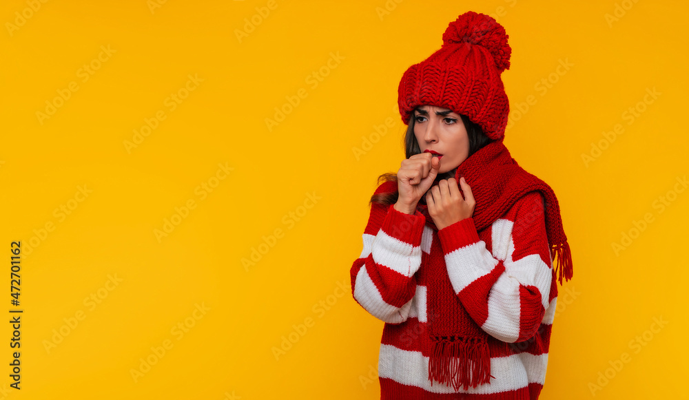 Tired exhausted young woman coughing due to seasonal throat disease isolated on yellow background