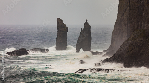 Europe, Faroe Islands. View during a storm of Eidiskollur and the twin stacks of Risin og Kellingin from the village of Tjornuvík on Streymoy Island. photo