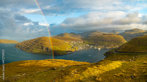 Europe, Faroe Islands. View of the village of Vestmanna with rainbow on the island of Streymoy photo