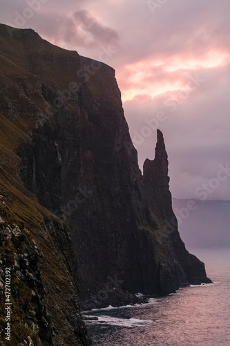 Europe, Faroe Islands. Morning view of Trollkonufingur, also known ass Witch's Finger, a pillar on the rugged coast of the island of Vagar.