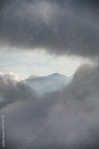 enchanting aerial view through the clouds on the winter mountain landscape