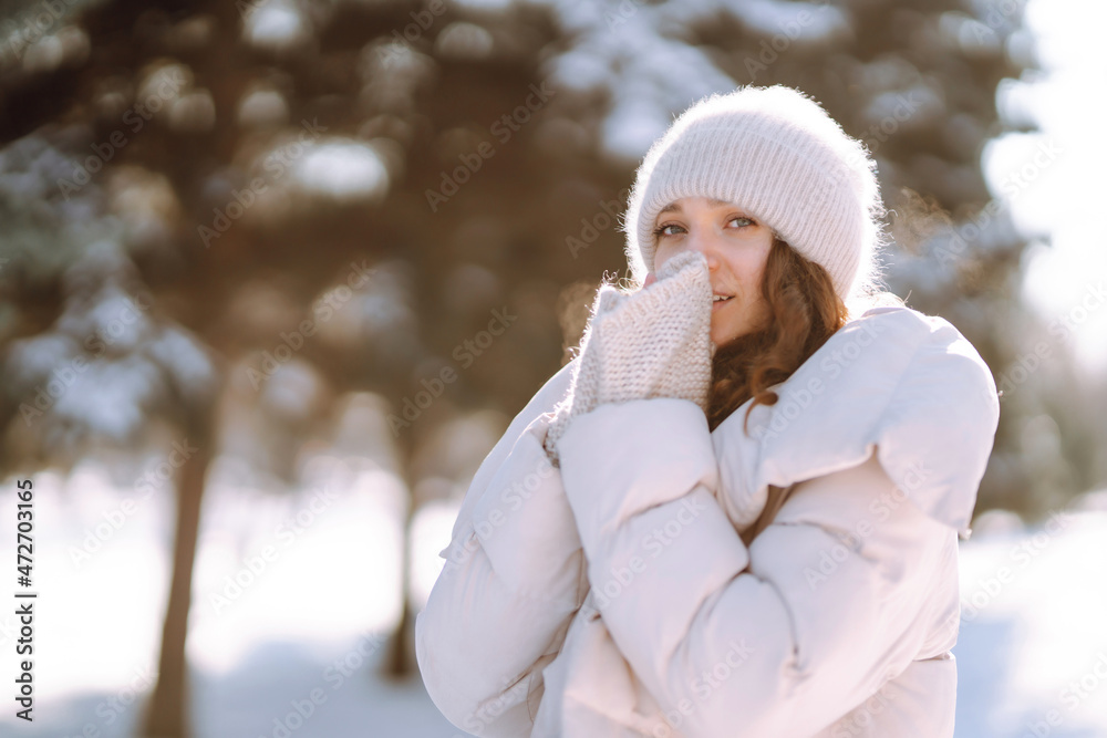 Happy woman in winter style clothes walking in the snowy park. Nature, holidays, rest, travel concept. Happy woman in winter style clothes walking in the snowy park. Nature, holidays, rest, travel concept.