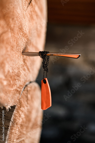 selective focus on a stucking in a tree small knife with case