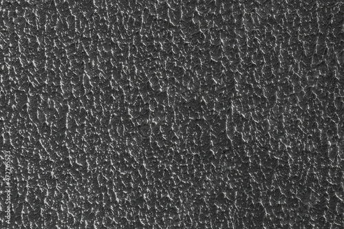 The surface of the embossed rough gray plaster on the wall.