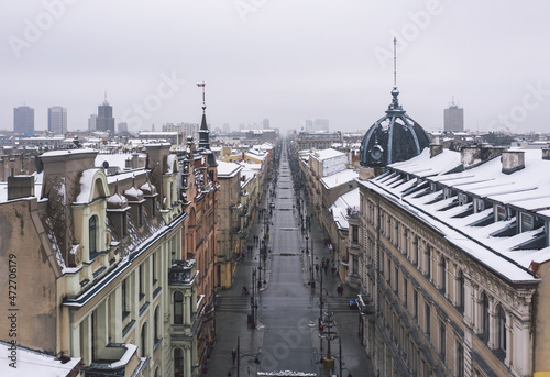 Obraz na płótnie Aerial winter cityscape of Lodz, Poland. View along the famous tourist attraction - Piotrkowska Street with rooftops covered in snow. w salonie