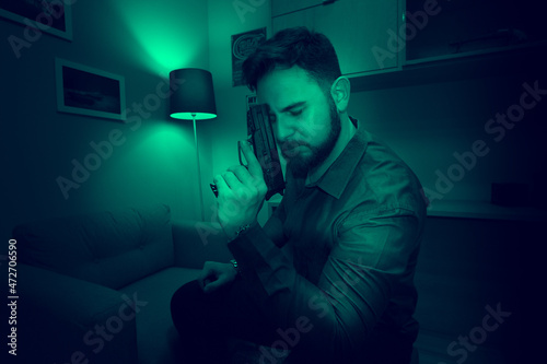 Armed man in the dark room