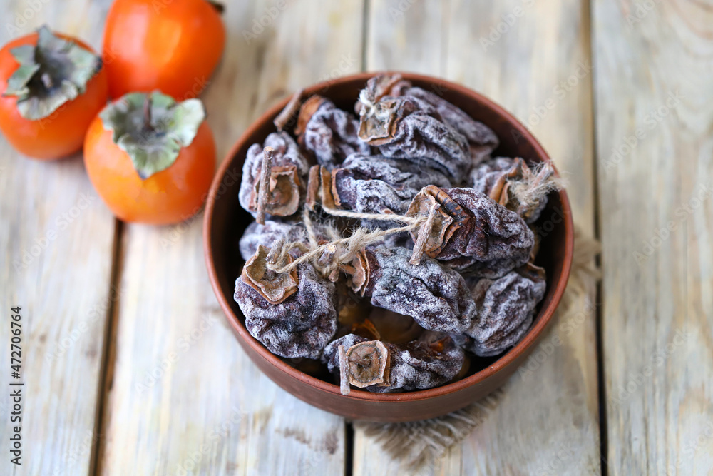 Selective focus. Dried persimmon in a bowl. Selective focus. Dried persimmon in a bowl.