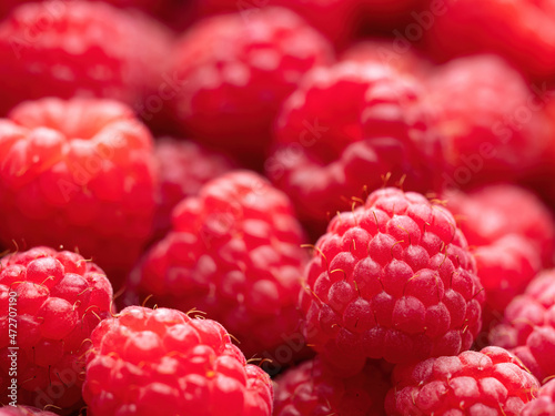 Fresh ripe red raspberries background close-up. Healthy organic food, summer vitamins, BIO viands, natural background. Copy space for your advertising text message.