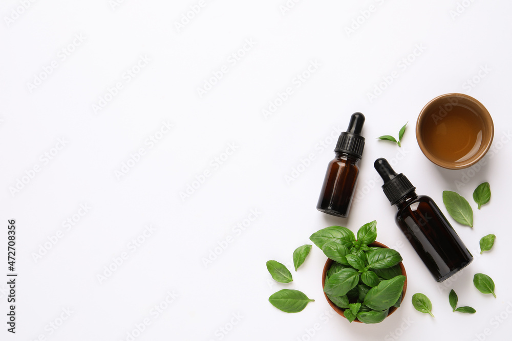 Essential basil oil with fresh leaves on white background, flat lay. Space for text - obrazy, fototapety, plakaty 