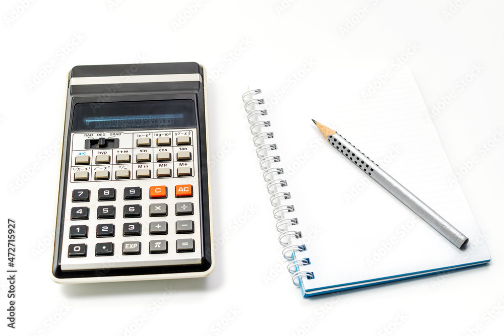 Calculator, pencil and notebook on white background. Close-up. Copy space Calculator, pencil and notebook on white background. Close-up. Copy space