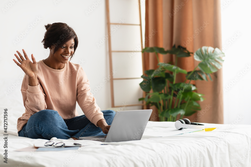 Black Female Making Video Call On Laptop Waving Hello Indoor Black Female Making Video Call On Laptop Waving Hello Indoor
