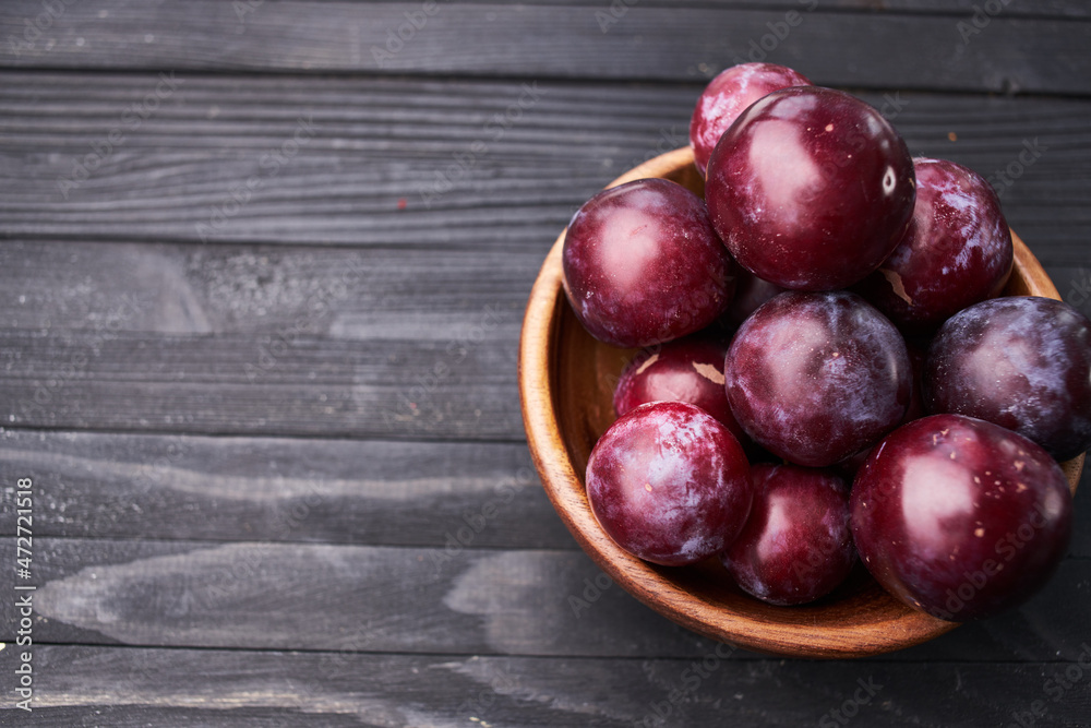 plums fruits natural products on a wooden table top view plums fruits natural products on a wooden table top view