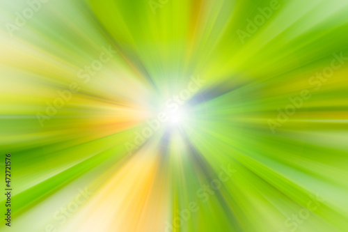 Bright yellow and green rays with white flash in the center