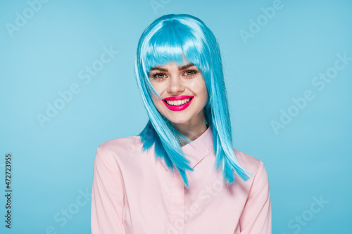 cheerful glamorous woman in pink shirt blue wig makeup model