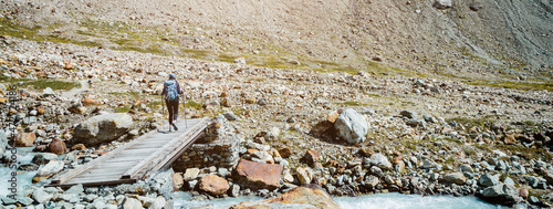 Women walk in mountain with backpack. Trekking and Hiking in nature