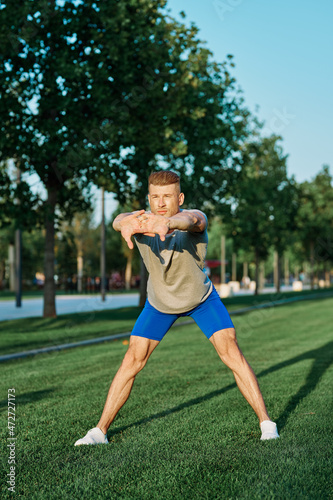 sporty man in the park on the lawn exercise lifestyle
