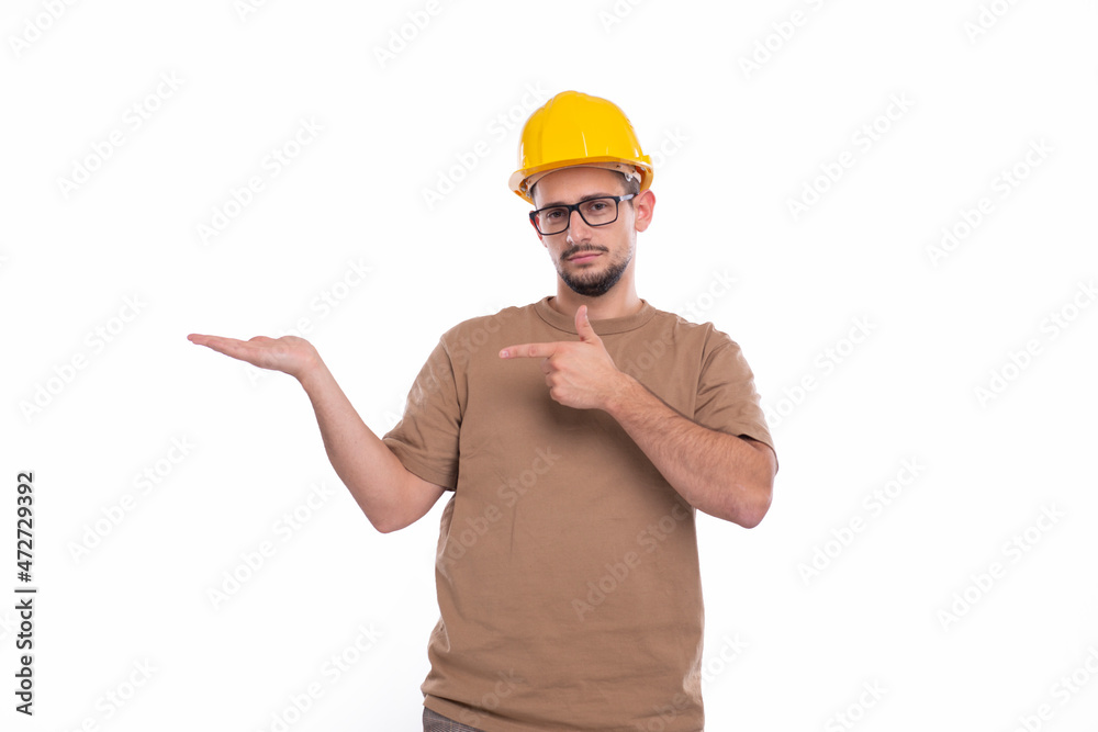 Builder Holding Hand to Side Pointing at It Isolated. Man Construction Worker Sign. Advertisment, Commercial, Business concept