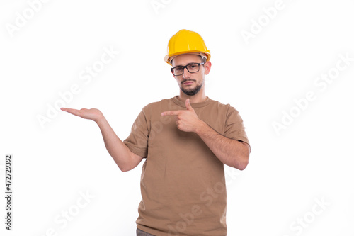 Builder Holding Hand to Side Pointing at It Isolated. Man Construction Worker Sign. Advertisment, Commercial, Business concept