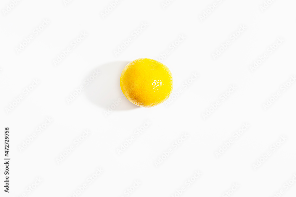 One whole tangerine on a white background. New Year and Christmas symbol. Isolate. Lifestyle. Close-up. View from above. Horizontal photo.