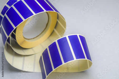 Roller tape blue self-adhesive label. Material for printing and marking products. Thermal label. Selective focus, copy space