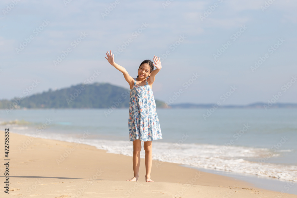 Enjoying little girl on the beach, Kid relaxing outdoor Enjoying little girl on the beach, Kid relaxing outdoor