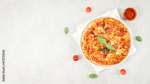 Round baked pizza in a plate with white kitchen napkin