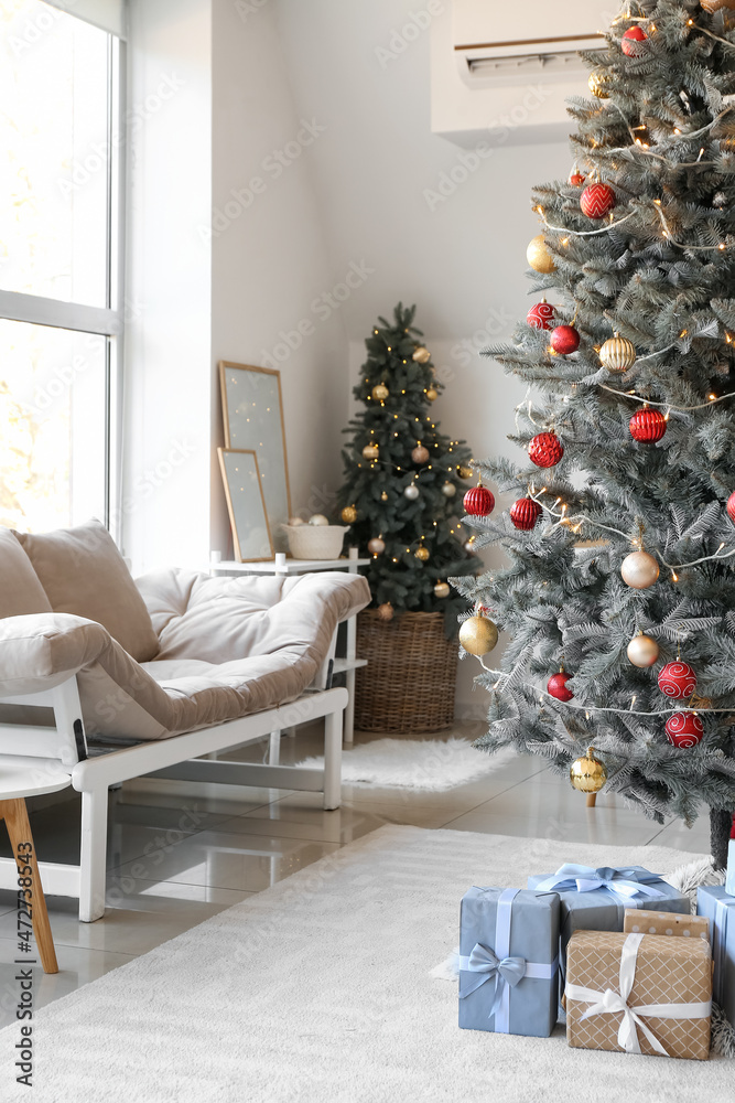 Interior of living room with Christmas trees and gifts