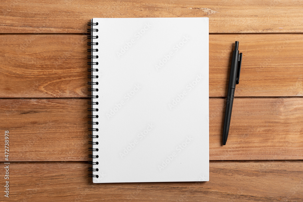 notebook and pen on wooden table notebook and pen on wooden table