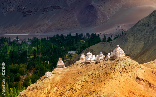 Buddhist Stupas and Himalayan mountains landscape of Ladakh, Union territory, India. Most people in Ladakh beleives in Buddhism. photo