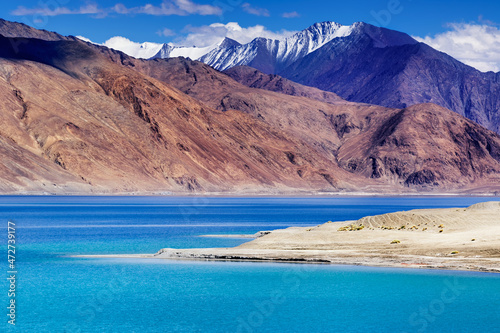 Blue water of Pangong tso (Lake). It is huge lake in Ladakh, shared by China and India along India China LOC border, Himalayan mountains alonside from India to Tibet. Leh, Ladakh, India