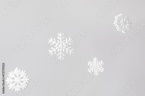 Fototapeta Naklejka Na Ścianę i Meble -  White snowflakes hanging on light background