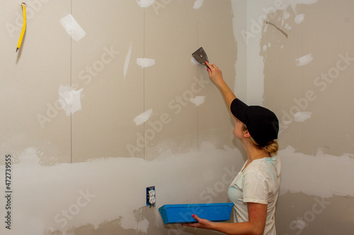 Kitchen Remodel Young Woman Filling Drywall Holes