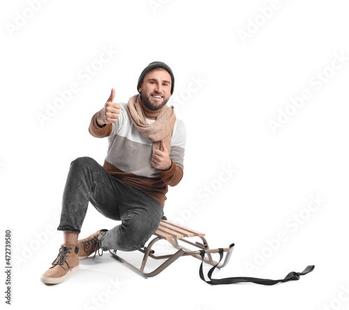 Young man with sled showing...