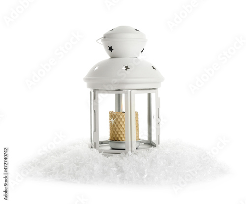 Beautiful Christmas lantern with burning candle and snow on white background