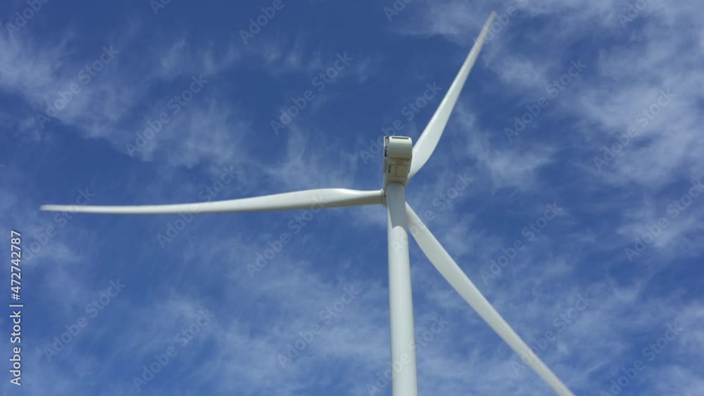 Windmill turbine spinning against a cloudy sky. Static shot. Windmill turbine spinning against a cloudy sky. Static shot.